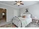 Charming bedroom features a decorative iron bed frame and a glimpse into an adjoining room at 12084 Cotton Aly, Alpharetta, GA 30009