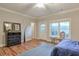 Bright bedroom with hardwood floors, outside access and a decorative dresser at 12084 Cotton Aly, Alpharetta, GA 30009