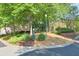 Well-maintained common area with lush greenery, landscaping and a pet waste station at 12084 Cotton Aly, Alpharetta, GA 30009