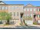 Attractive townhomes featuring brick facades, private garages, and landscaped front yards at 12084 Cotton Aly, Alpharetta, GA 30009