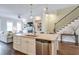 Open-concept kitchen with an island, stainless steel appliances, and adjacent living area at 12084 Cotton Aly, Alpharetta, GA 30009