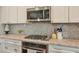 Stylish kitchen showcasing stainless steel appliances, granite countertops, and mosaic backsplash at 12084 Cotton Aly, Alpharetta, GA 30009