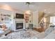 Cozy living room featuring a fireplace, built-in shelves, and view of the staircase at 12084 Cotton Aly, Alpharetta, GA 30009