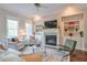 Comfortable living room with a fireplace, built-in shelves, and natural light at 12084 Cotton Aly, Alpharetta, GA 30009