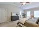 Spacious main bedroom featuring ample natural light, a large dresser, and a comfortable seating area at 12084 Cotton Aly, Alpharetta, GA 30009