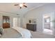 Bright main bedroom with neutral tones, a comfortable bed, and a view into the en-suite bathroom at 12084 Cotton Aly, Alpharetta, GA 30009