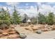 Patriotic memorial with a flag, statue, and water feature surrounded by rocks and manicured landscaping at 12084 Cotton Aly, Alpharetta, GA 30009