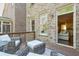 Inviting outdoor patio with comfortable seating and view through windows and door into the home's interior at 12084 Cotton Aly, Alpharetta, GA 30009