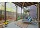 Inviting outdoor patio with lounge chairs, throw pillows, and lush landscaping for relaxation at 12084 Cotton Aly, Alpharetta, GA 30009