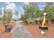 A whimsical yellow paint sculpture alongside a park bench and sidewalk with views of the community at 12084 Cotton Aly, Alpharetta, GA 30009