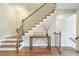 Inviting staircase with wood and iron railings, showcasing a stylish table and decor at 12084 Cotton Aly, Alpharetta, GA 30009
