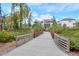 Picturesque walking trail with a charming bridge showcases the community's commitment to outdoor living at 12084 Cotton Aly, Alpharetta, GA 30009