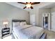 Neutral bedroom features a queen bed, ceiling fan, and two entry doors at 1897 8Th St, Atlanta, GA 30341