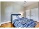 Bright bedroom with hardwood floors and a blue and white striped bedspread at 1897 8Th St, Atlanta, GA 30341