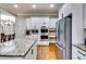 Modern kitchen with granite countertops, stainless steel appliances, and white cabinets at 1897 8Th St, Atlanta, GA 30341
