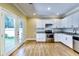 Kitchen featuring an oven, white cabinets, granite countertops, and double glass doors at 1897 8Th St, Atlanta, GA 30341