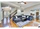 Open-concept living room with hardwood floors, staircase, and comfortable seating area at 1897 8Th St, Atlanta, GA 30341