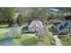 Aerial view of a two-story brick home on a landscaped corner lot with a circular driveway at 198 Grandmar Chase, Canton, GA 30115