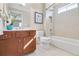 Well-lit bathroom features a tub-shower combination, storage vanity, framed art, and modern fixtures at 198 Grandmar Chase, Canton, GA 30115