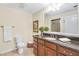 Bathroom featuring dark vanity, toilet, shower, and decorative mirror at 198 Grandmar Chase, Canton, GA 30115