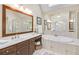 Bathroom with soaking tub, vanity with sink, and expansive mirror to reflect the natural light at 198 Grandmar Chase, Canton, GA 30115