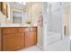 Bathroom with a white countertop, brown cabinetry and tub/shower with tile surround at 198 Grandmar Chase, Canton, GA 30115