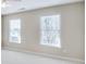 Bright bedroom featuring neutral walls, white trim, and two windows with natural light at 198 Grandmar Chase, Canton, GA 30115