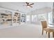 Bedroom with built-in bookshelves, ceiling fan and large windows offering a scenic view at 198 Grandmar Chase, Canton, GA 30115