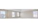 Spacious bedroom with neutral walls, white trim, and three large windows providing natural light at 198 Grandmar Chase, Canton, GA 30115