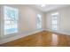 Bright bedroom with hardwood floors, two large windows, and an access door at 198 Grandmar Chase, Canton, GA 30115