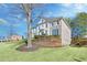 Elegant two-story home with a brick and stucco facade, professional landscaping, and a charming balcony at 198 Grandmar Chase, Canton, GA 30115