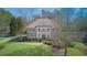 Beautiful two-story brick home with a well-manicured lawn, mature trees, and elegant landscaping at 198 Grandmar Chase, Canton, GA 30115