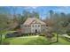 Elegant two-story brick home with manicured landscaping, a circular window, and mature trees at 198 Grandmar Chase, Canton, GA 30115