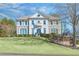 Beautiful two-story home featuring a well-manicured lawn, elegant architectural details, and mature trees at 198 Grandmar Chase, Canton, GA 30115