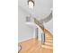 Elegant foyer showcasing a winding staircase with decorative iron railings and hardwood floors at 198 Grandmar Chase, Canton, GA 30115