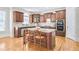 Charming kitchen boasts wooden cabinets, a center island, and a modern oven at 198 Grandmar Chase, Canton, GA 30115