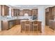 Kitchen features stainless appliances, wooden cabinets, and a central island at 198 Grandmar Chase, Canton, GA 30115