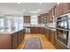 Open kitchen with wooden cabinets, stainless appliances, and granite countertops at 198 Grandmar Chase, Canton, GA 30115
