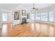 Bright and airy living room featuring hardwood floors, fireplace, built-in bookshelves, and large windows at 198 Grandmar Chase, Canton, GA 30115