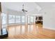 Bright living room with hardwood floors, expansive windows, and an open connection to the adjacent kitchen at 198 Grandmar Chase, Canton, GA 30115