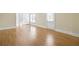 Spacious living room featuring gleaming hardwood floors, neutral walls, and a door leading to outdoor space at 198 Grandmar Chase, Canton, GA 30115