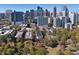 Stunning aerial view of the property nestled among mature trees with the city skyline in the background at 273 12Th Ne St # 421, Atlanta, GA 30309