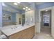 Bathroom featuring double sinks, a soaking tub, and light-colored walls at 273 12Th Ne St # 421, Atlanta, GA 30309