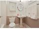 Bright bathroom features a toilet, pedestal sink, and ample towel storage at 273 12Th Ne St # 421, Atlanta, GA 30309