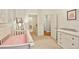 Bedroom with pink accents, neutral walls, and a view into the bathroom and closet at 273 12Th Ne St # 421, Atlanta, GA 30309