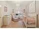 Comfortable Bedroom with crib, dresser, chair, and lots of natural light at 273 12Th Ne St # 421, Atlanta, GA 30309