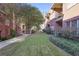 Beautifully landscaped courtyard with walkways and mature trees between brick apartment buildings at 273 12Th Ne St # 421, Atlanta, GA 30309