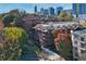 Beautiful multi-story brick building with balconies, surrounded by colorful trees and lush landscaping at 273 12Th Ne St # 421, Atlanta, GA 30309