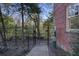 Exterior view of building with brick wall and a black metal fence and gate at 273 12Th Ne St # 421, Atlanta, GA 30309