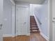 Hallway with hardwood floors, stairs, and a storage closet at 273 12Th Ne St # 421, Atlanta, GA 30309